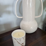 Aromatherapy candle in marbled tumbler with lid.