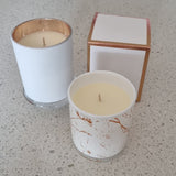 Aromatherapy candle in marbled tumbler with lid.