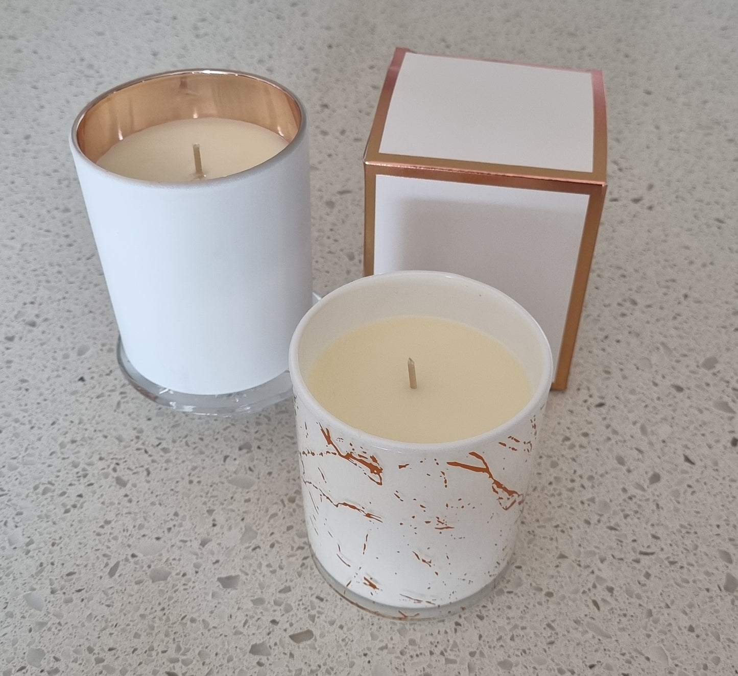 Aromatherapy candle in marbled tumbler with lid.